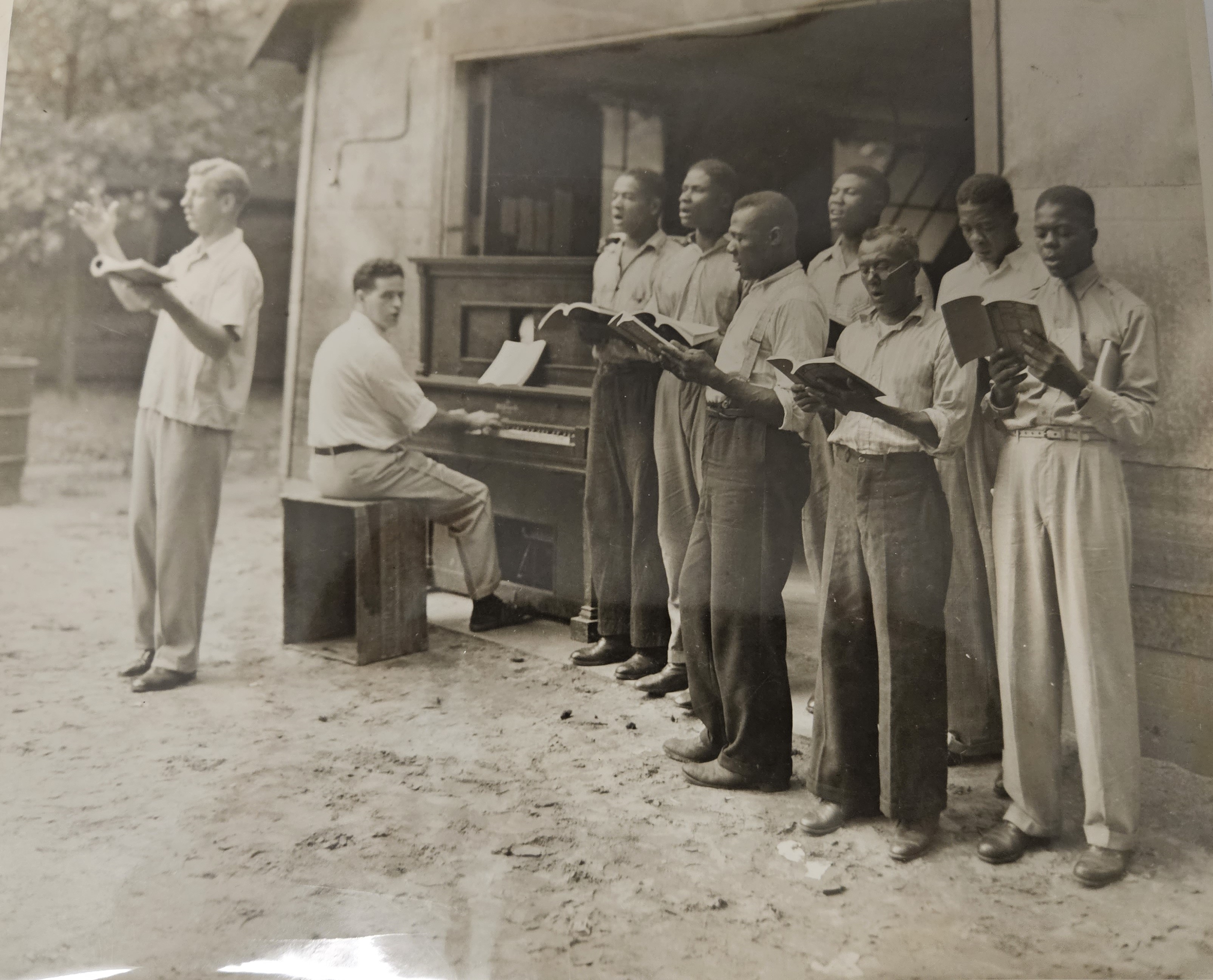 photo - piano w/line of men singing